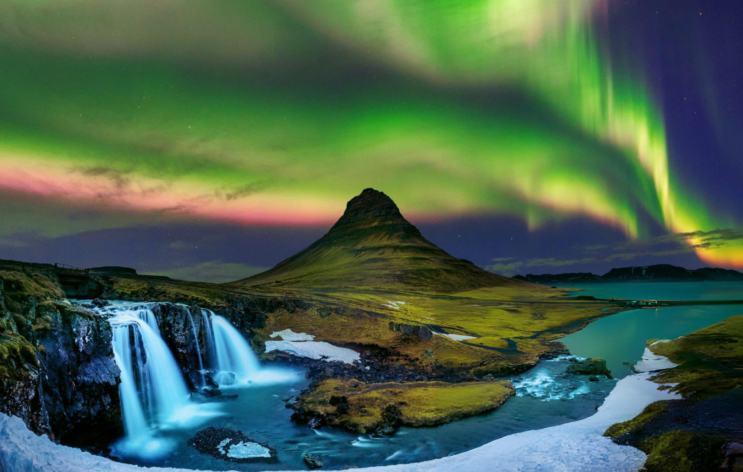 Kirkjufell mountain beneath the northern lights in Iceland